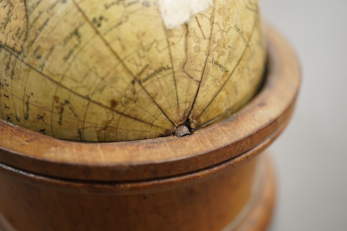 A Newton’s New and Improved Terres[trial] Glo[be], (pocket globe), 3inch diameter, rotating in a 3.3/4 inch later turned mahogany stand, plotting Cook’s voyage of the 1770’s, restored, as specified by Baynes-Cope, but wi